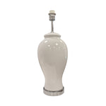A white ceramic table lamp base with a glossy finish and chrome detailing at the bottom.