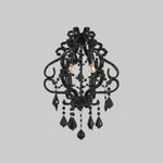 Black chandelier with crystal accents on a gray background