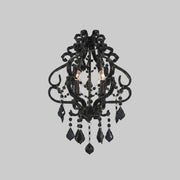 Black chandelier with crystal accents on a gray background